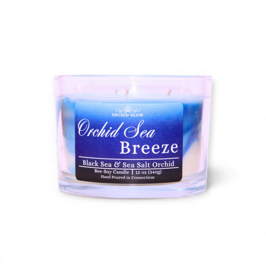 Candle labeled 'Orchid Sea Breeze' with a blue label on a white background